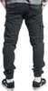 A person wearing black cargo pants and black sneakers, shown from the back. Produktbild-Vorschau