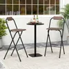 Two folding bar stools and a high table are set up on an outdoor patio. Produktbild-Vorschau