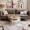 A living room scene featuring a sofa, coffee table, rug, and artwork. Náhľad obrázku produktu