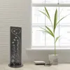 A decorative garden sign with the text "Herzlich Willkommen" is placed indoors next to a window with a potted plant. Produktbild-Vorschau