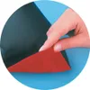 A hand is shown peeling back a layer of red material from a black material. Produktbild-Vorschau