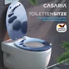 A toilet seat with a decorative design of stepping stones on a path over water. Produktbild-Vorschau