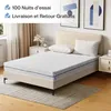A mattress on a bed frame with pillows, in a bedroom setting. Two framed pictures hang on the wall in the background. Voir les images du produit