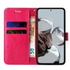 A pink flip phone case with floral and butterfly designs, showing card slots and a banknote. Produktbild-Vorschau