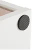 Close-up of the corner of a white cabinet with a textured gray foot pad attached. Voir les images du produit