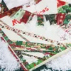 Christmas-themed washi tape rolls scattered on a surface covered with artificial snow, with some tape arranged in a banner shape. Produktbild-Vorschau