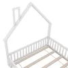 A close-up view of the top corner of a white wooden house-shaped bed frame, showing the roof structure and side railing. Produktbild-Vorschau