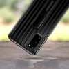 A close-up shot of the back of a black Samsung phone case with a ribbed texture and a kickstand. Náhled obrázku produktu