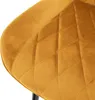 A close-up shot of the quilted seat of a mustard yellow velvet chair. Náhľad obrázku produktu