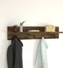 A rustic wooden coat rack shelf mounted on a white wall, displaying decorative items and clothing. Produktbild-Vorschau
