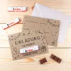 Birthday invitations with Kinder chocolates on a wooden surface. Produktbild-Vorschau