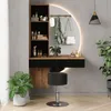 A modern vanity set with a mirror, shelves, and a stool in a room with plants and a pendant light. Voir les images du produit