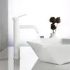 A white faucet is running water into a white sink, with decorative pine cones in a vase in the background. Náhled obrázku produktu