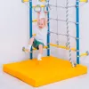 A child is playing on a gymnastics apparatus with a mat. Produktbild-Vorschau