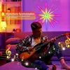 A young person plays an acoustic guitar in a room with colorful LED lighting and musical notes overlaid on the image. Produktbild-Vorschau