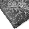 A close-up view of a gray chair cushion with a white abstract floral pattern. Produktbild-Vorschau