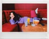 A woman is lying on a red couch with drinks and snacks on a table. Produktbild-Vorschau