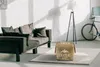 A living room scene with a sofa, ottoman, floor lamp, and bicycle. Náhľad obrázku produktu