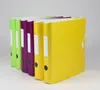 A row of colorful binders on a plain background. Voir les images du produit