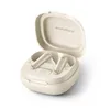 A pair of cream and gold wireless earbuds are shown inside their open charging case. Podgląd zdjęcia produktu