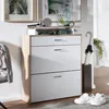 A shoe cabinet with drawers in a hallway setting, next to a coat rack and an umbrella stand. Náhled obrázku produktu