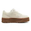 A side view of a single beige Puma sneaker with a brown sole, isolated on a white background. Produktbild-Vorschau
