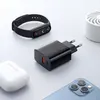 A collection of electronic accessories including a smart band, a charger, wireless earbuds, and a smartphone, arranged on a light gray surface. Anteprima dell’immagine prodotto