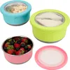 Four food storage containers with lids, three filled with food, and one lid separate. Produktbild-Vorschau