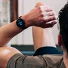 A person is checking their smartwatch during a workout. Náhľad obrázku produktu
