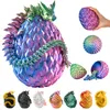 A collage of dragon egg figures in various colors, with a large, open dragon egg in the center showing a dragon inside. A hand is holding a smaller dragon egg in the upper right corner. Produktbild-Vorschau