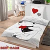 A children's bedding set featuring a cartoon bear is displayed on a bed in a bedroom setting. Produktbild-Vorschau