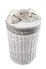 A white wicker laundry basket with a plush elephant toy on the lid. Podgląd zdjęcia produktu