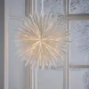 A large white paper star decoration hangs in a window with a snowy winter scene visible outside. Podgląd zdjęcia produktu