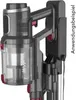 A close-up view of a black and gray MAXXMEE cordless stick vacuum cleaner mounted on its charging stand. Produktbild-Vorschau