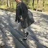 A person walking up stairs with a dog in a bag. Produktbild-Vorschau