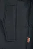 A close-up view of a black jacket with a pocket and a small Union Jack flag emblem. Anteprima dell’immagine prodotto