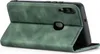 A green flip cover case for a smartphone is shown standing open. Produktbild-Vorschau
