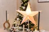 A decorated table setting with a Christmas tree in the background. Náhled obrázku produktu