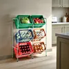 A multi-tiered storage rack filled with various items, including produce, bottled drinks, and other beverages, in a kitchen setting. Náhled obrázku produktu