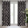 Two curtains with a leaf pattern hang in front of a window. Produktbild-Vorschau