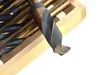 A close-up view of a drill bit from a set of drill bits, resting in a wooden case. Voir les images du produit