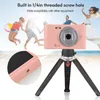 People enjoying a beach day with a pink digital camera on a tripod in the foreground. Náhled obrázku produktu