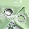 A close-up view of two grommets on a green curtain with a white wave pattern. Produktbild-Vorschau