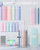 A collection of school stationery items arranged on a light gray surface. Produktbild-Vorschau