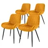 Four yellow velvet dining chairs with black metal legs are arranged on a white background.