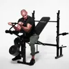 A man is using a weight bench in a studio setting. Podgląd zdjęcia produktu