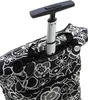 Close-up view of the handle and top of a patterned shopping trolley bag. Podgląd zdjęcia produktu
