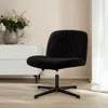 A black velvet office chair is shown in a room with a white dresser and a vase of flowers. Voir les images du produit
