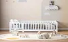 A child's bedroom with a white wooden bed, toys, and decorative elements on the wall. Anteprima dell’immagine prodotto