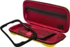 An open yellow and red protective case for a Nintendo Switch Lite, with a black frame accessory in the foreground. Náhľad obrázku produktu